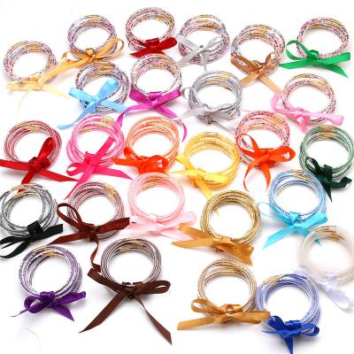 China Christmas CLASSIC Jelly Bowknot Silicone Stacked Bracelet All Weather Jelly Bangles Glitter Filled Bracelet for sale