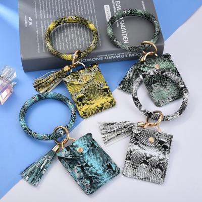 China New Update PU Snakeskin Wristband Key Chain Tassel Wallet ID Wristbands Anti-Theft Credit Card Holder Key Chain for sale