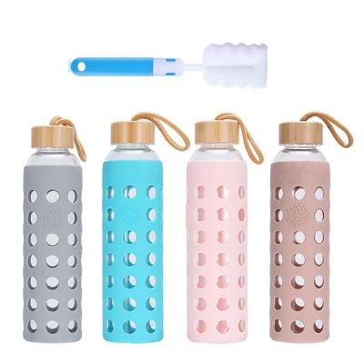 China Sustainable Portable Glass water bottles with silicone sleeve  bamboo lid Round hollow cup cover  straight cylinder glass water bottles for sale