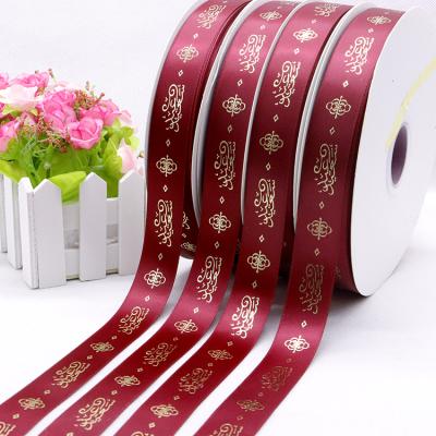 China Good quality viable wholesale custom 1 inch 25 mm wine red color 3d embossed gold foil printed satin ribbon for sale