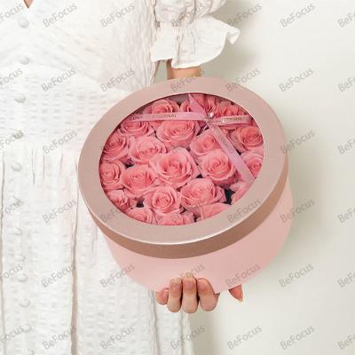 China Recycled Materials custom luxury flower wedding favors gifts pink round tube window box packaging for guests souvenirs luxury with logo for sale