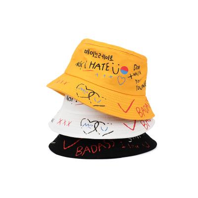 China Newest Love Smiley Face Scrawl Full Print Yellow And White Design Hip Hop Hats Eco-friendly Dye Sun Protection Bucket Hats for sale