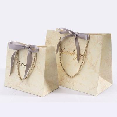 China Materials Factory Paper Bag Clothing Packaging Bag Recycled Shipping Marble Creative Gift With Ribbon Gift Bag for sale