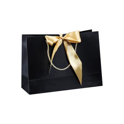 China High Quality Disposable Luxury Retail Cheap Twisted Handle Black Gift Bag With Ribbon for sale