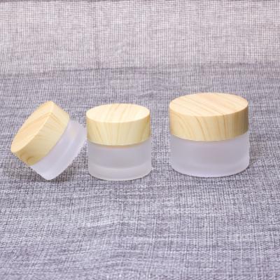 China Personal care 5g 10g 15g 30g 50g frosted glass jar with plastic material style bamboo cap for face cream cosmetic for sale