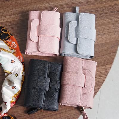 China Waterproof Women's Fashion Wallet Mini Coin Purse Litchi Pattern Short Suction Belt Buckle Wallet for sale