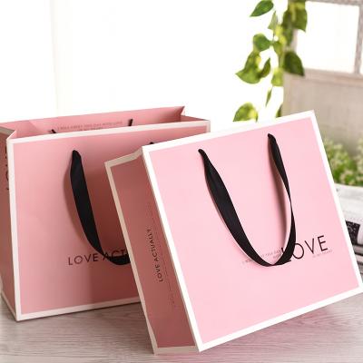 China Recyclable Recycled Glossy Custom Paper Handle Kraft Paper Gift Bag With Your Logo for sale