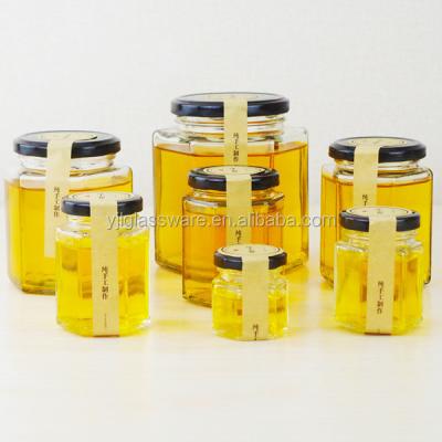 China Steamable Wholesale Price Hot Selling Glass Honey Jar Hexagon Accepting Custom Logo for sale