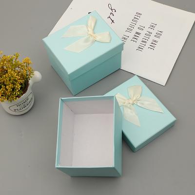 China Factory Price 12*10*9CM Recyclable Perfume Auto Parts Gift Box Light Blue Gift Box With Bow Makeup Cosmetic Case for sale