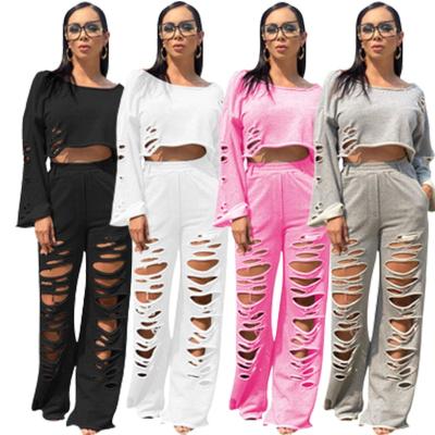 China Fall 2021 dropship fashion two piece set hole long sleeve crop top casual anti-static flare solid top pants for sale