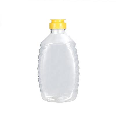 China PET Clear Plastic Honey Jar Empty Squeeze Honey Bottle Container Holder With Flip Lid For Storing And Dispensing for sale