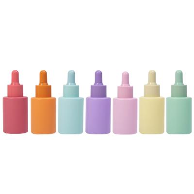 China Empty 30ml Flat Shoulder Cosmetic Bottle Colorful Round Shaped 1oz Glass Cosmetic Essence / Serum Dropper for sale