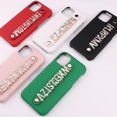 China Custom Made Premium Pebble Letter Metal Name Dropshipping DIY Phone Case Phone Leather Strap Leather Phone Case for sale