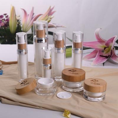 China Household Products Containers Acrylic Cosmetic Bottle With Wooden Lids for sale