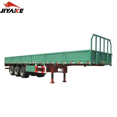 China 60 Ton Tri Truck Trailer Axle Cargo Transport Sidewall Barrier Trailer Dropside Tips Open Semi Truck Trailer With Twist Lock for sale