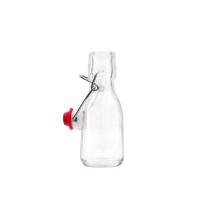 China Eco-friendly Recyclable Wholesale Juice Water Glass Bottle 100ml Beverage Drinking Bottle Container With Flip Swing Lid for sale