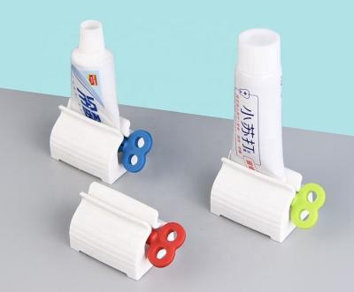 China Tube Toothpaste Seat Holder Viable Rolling Rolling Holder Rotate Automatic Bathroom Toothpaste Squeezer Toothpaste Dispenser for sale