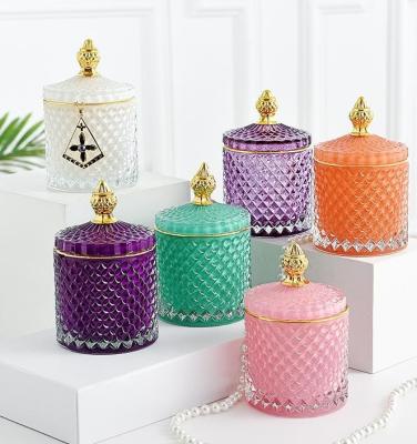 China Luxury Colorful Glass Religious Activities Cup Candle Jar Holder With Handle Cover Lid Can Candy Storage for sale