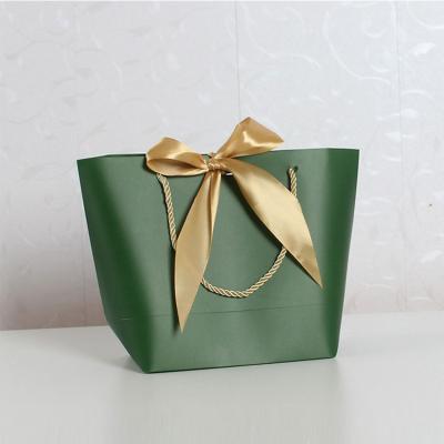 China Recycled Materials Manufacturers Custom Gift Luxury Shopping Paper Bag With Ribbon for sale