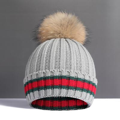 China Large real raccoon autumn and winter plush wool ball woolen woolen ball super hat women's fur hat thickened soft warm knitting hat for sale