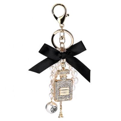 China Eco-friendly Creative Handmade Pearl Alloy Rhinestone Perfume Bottle Key Chain Pendant Bow Chain for sale