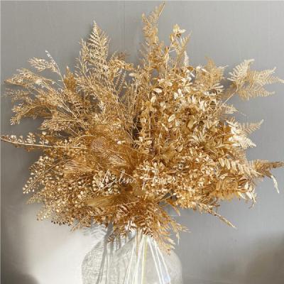 China Durable Gold Color Wholesale Plastic Leaves Stage Design Gold Color Decoration Artificial Flowers for sale