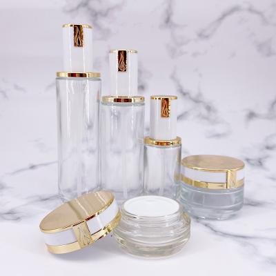 China Personal Care Thick Bottom Transparent Skin Care Set Empty Glass Cosmetic Bottle Empty Essence Cream Oil Bottle for sale