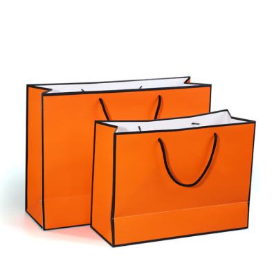 China Other Paper Packaging Orange bag with black line Stand up Kraft card Paper tote Bag custom Handles for Shopping Clothing Gift Paper for sale