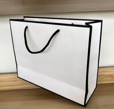 China Handmade Paper Wrapping In Solid Color Running Stand Up Tote Bag Festival Gift Wrapping Paper Bag With Polyester Twine Handles For Shopping for sale