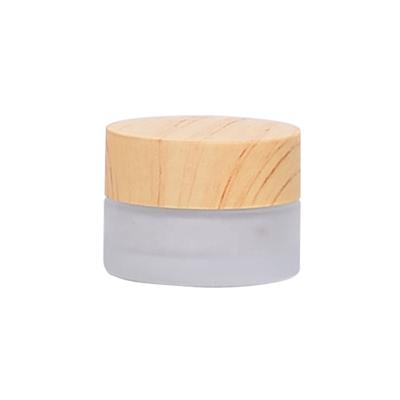 China Small Cosmetic Glass Jar 5ml Eye Cream Cosmetic Jar 5g Frosted Glass Jar With Wooden Lid for sale