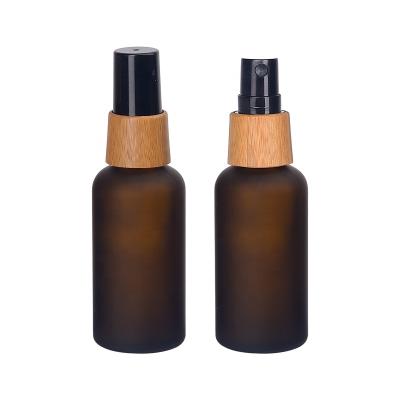 China Matte Brown Personal Care Cosmetic Bottle 50ml Frosted Amber Glass Bottles With 18/415 Bamboo Wooden Mist Spray for sale