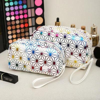 China Customized Geometric Pressing Cosmetic Bag Portable Fashion Makeup Bag Lady Small Clutch Bag Geometric for sale