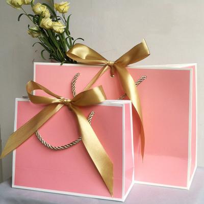 China Recyclable Custom Pink Paper Jewelry Bag With Ribbon Handle With Logo for sale