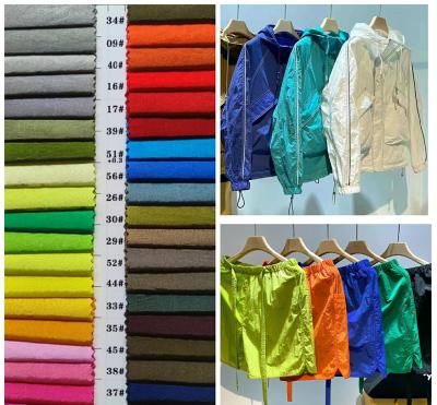 China High quality 100%wrinkle 70D pressure light fabric water repellent windproof high density nylon shiny fabric for jacket,sports shorts for sale