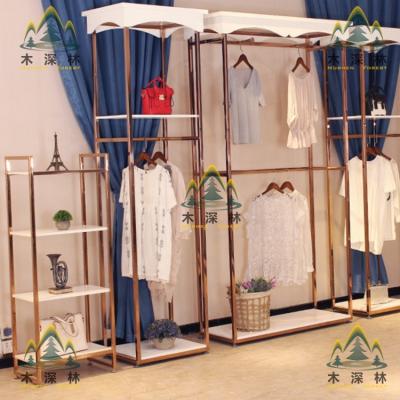 China Exquisite and luxury environment-friendly apparel display stand with pink structure and gold wood together perfect for apparel and things display for sale