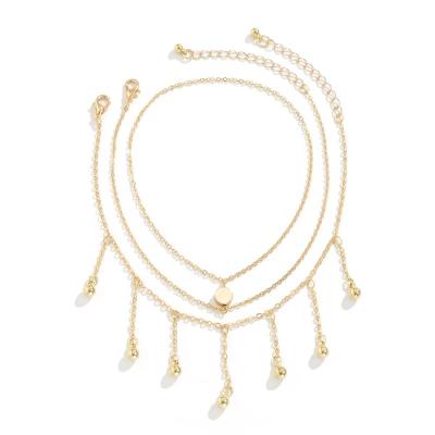 China Fashionable Hot Selling 2 Pcs Set Hanging Ball Tassel Anklet Layered Anklet Jewelry 2022 New Cross Anklets For Women for sale