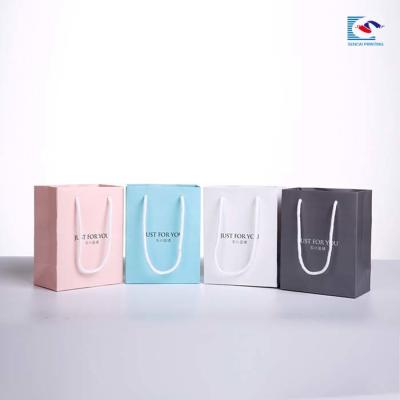 China Single color printing paperboard crystal ornament packaging paper bag with handles and name card for sale