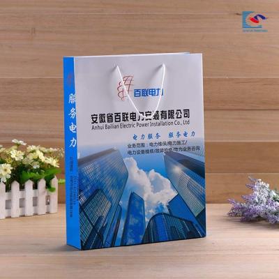 China Customs logo color printing art paper business gift paper bags Anniversary celebration paper bag for sale