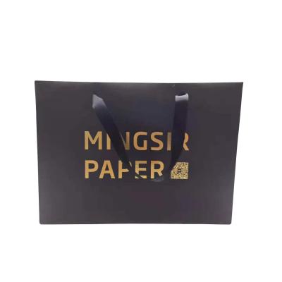 China Handmade Wholesale Custom Gold Foil Stamping Logo Black Paper Bag Clothing Shopping Packaging Paper Bag for sale