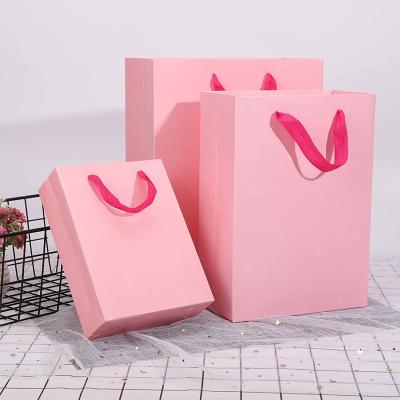 China Wholesale Custom Handmade Carry Bag Logo Garment Purchasing Storage Pink Paper Bag Packaging for Clothing High Quality Cosmetics Retail Bag for sale