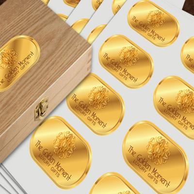 China Waterproof OEM PET PVC PP Embossed Glossy Golden Color Logo Sticker Printed Clear Gold Foil Stamping Label for sale