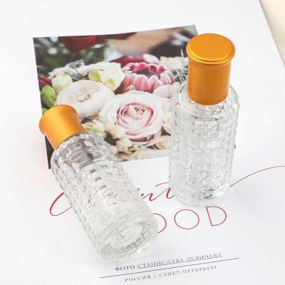 China Mini Cosmetic Supplier 30ml Small Round Embossed Perfume Essential Oil Car Skin Care Glass Cosmetic Bottle for sale