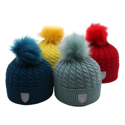 China COMMON Wholesale Thick Winter Multicolor Cable Knit Logo Beanie Customized With Faux Fur Pom Pom for sale