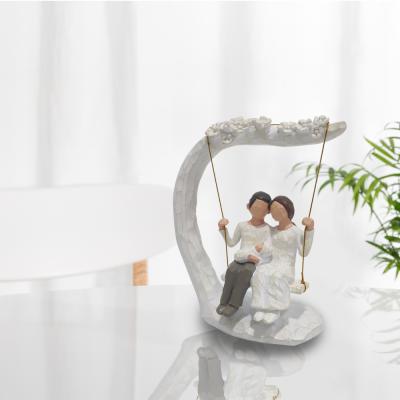 China Happy Europe Parents Hold Their Children In Swinging Home Decoration And Gift for sale