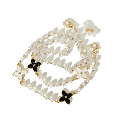 China Fashoin simple black and white sweater temperament pearl clover dripping oil small perfume glasses chain chain universal for sale