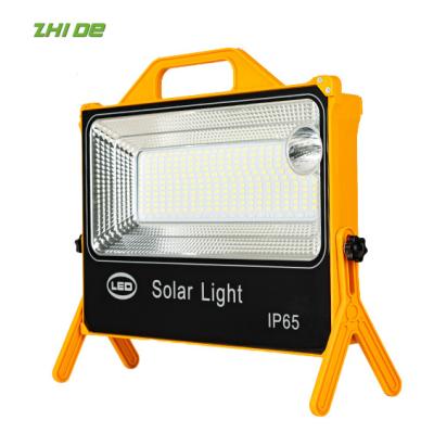 China ABS 100W 200W universal multifunctional portable solar power source emergency light projection light camping light for sale