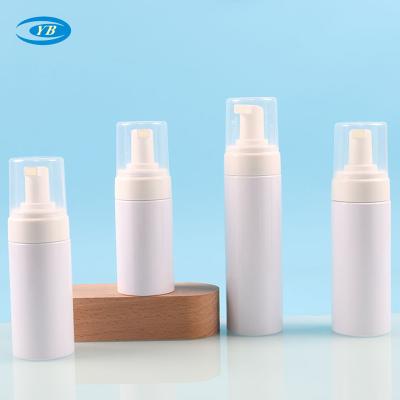 China Cosmetic Round hand sanitizer facial cleanser pump bottle silicone brush white plastic bottle wholesale for sale