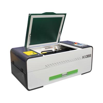 China Water Cooled 3050 Mini Portable Laser Engraving and Cutting Machine with Lifting Platform for sale