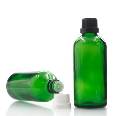 China Personal Care 100ml Green Round Glass Bottle With Screw Caps Hair Oil Bottles With Empty Cosmetic Dropper Container for sale