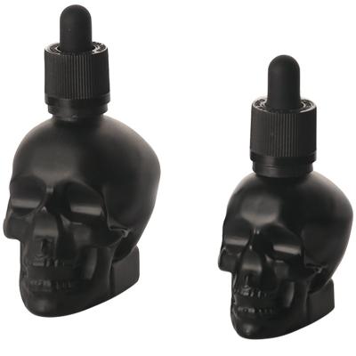 China Personal Care Wholesale 30ml 60ml Black Frosted Skull Head Shape Essential Oil Glass Dropper Bottle for sale